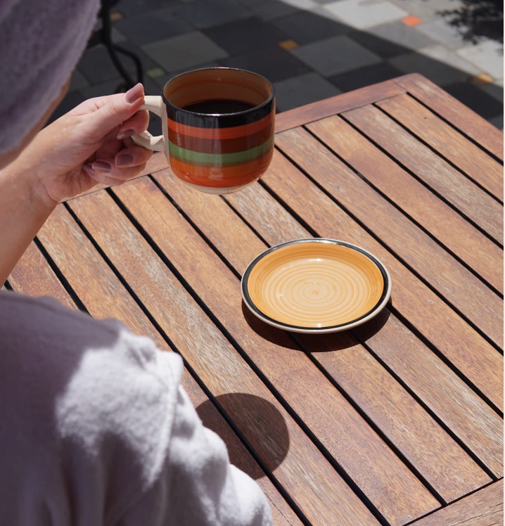 A cup of coffee on the wooden terrace table
